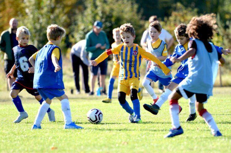Young football player dribbling